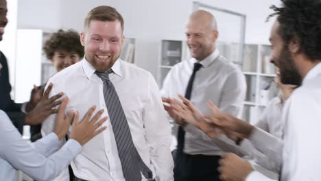 happy businessman trust falling on colleagues standing in circle