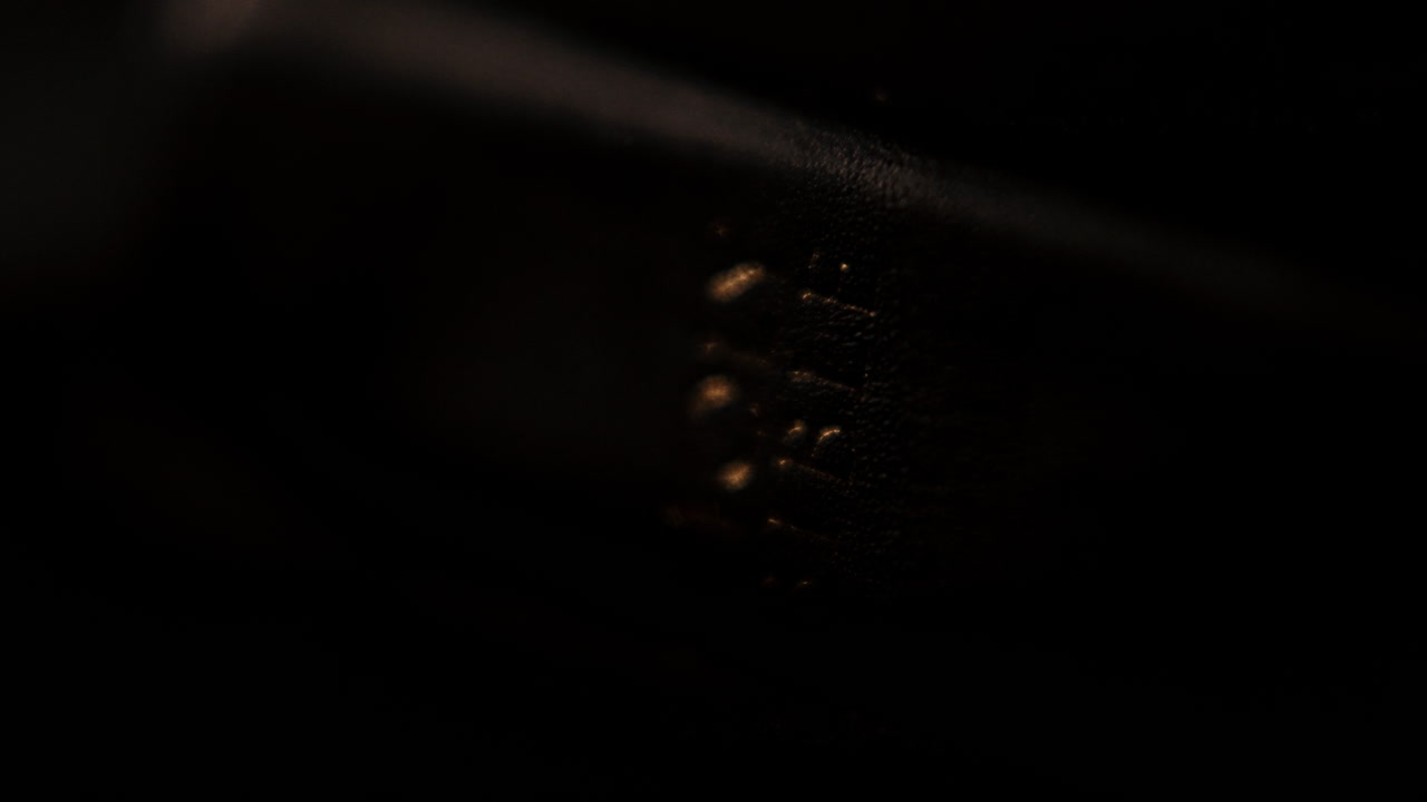 Close-up of stitched object in dark background