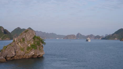 ha long bay cruise tour ships travel by karst limestone mountains ranges, vietnam