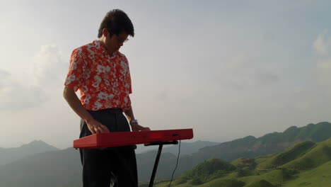 aerial view of pianist plays on grand piano in the mountains