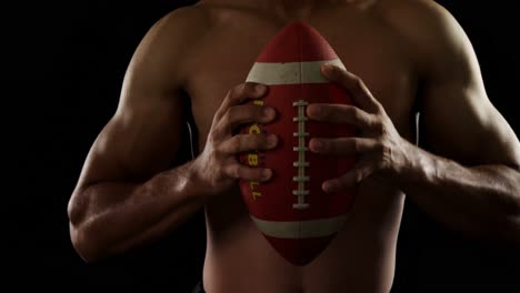 american football player holding ball 4k