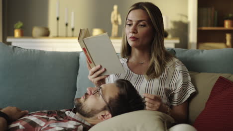 Couple reading a book on the couch