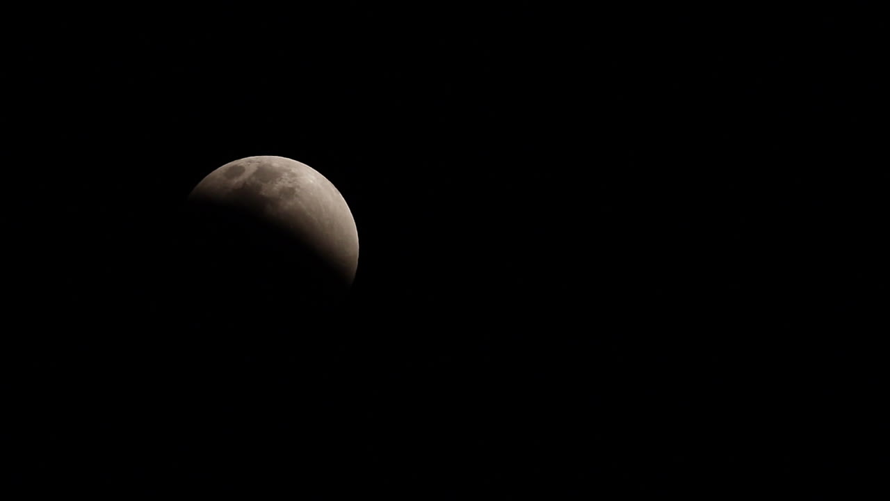 Quarter moon glows in black night sky, nature background