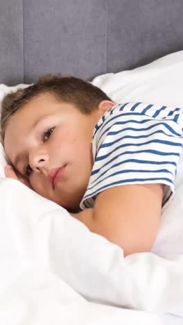 cute boy falls asleep in bed on white bed linen a childs dream cute boy falls asleep in bed on white bed linen a childs dream cute gentle schoolboy boy