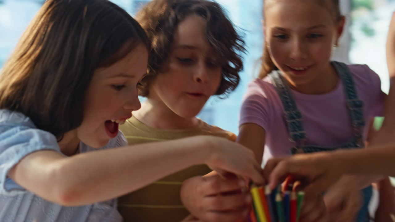 Schoolchildren have art lesson sitting table together closeup. Woman teacher