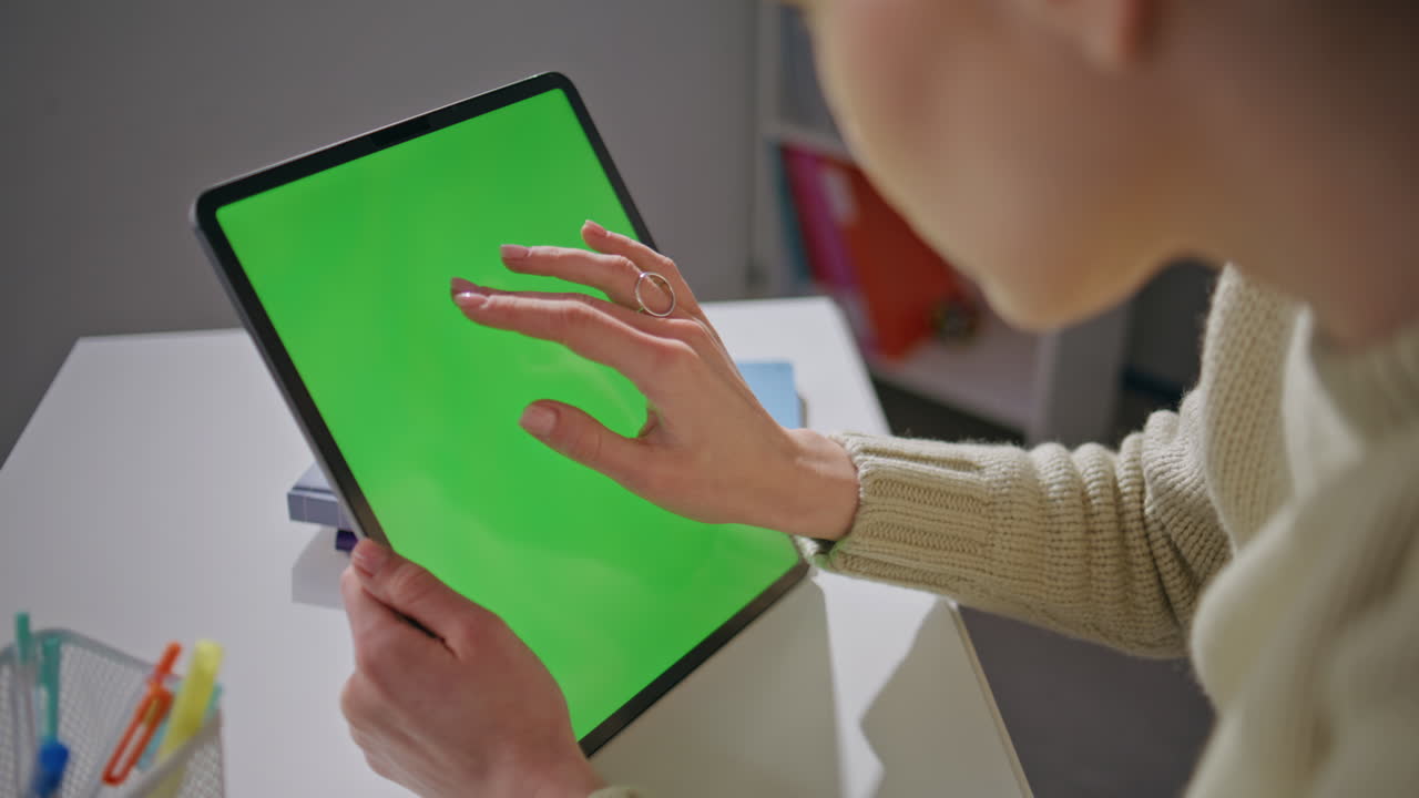 Teacher using chromakey tablet workplace closeup. Woman holding mockup computer