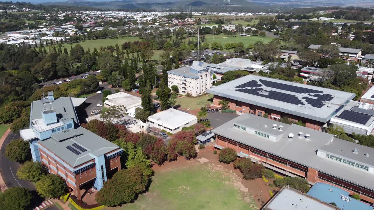 4K Aerial view of commercial buildings with solar panels on the roof in Toowoomba, Australia