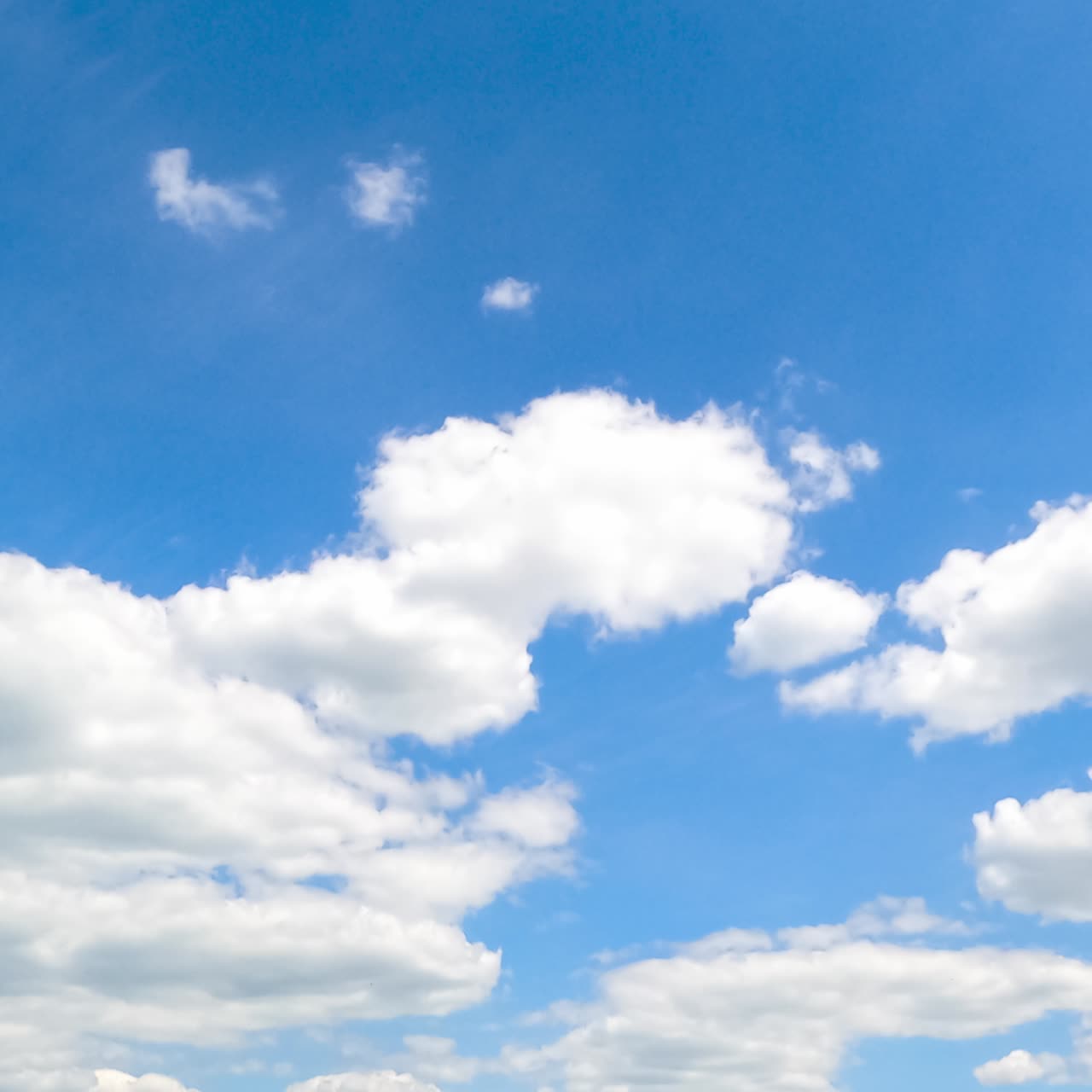 Beautiful transforming cloudscape in the bright blue sky. Fantastic timelapse on summer daytime