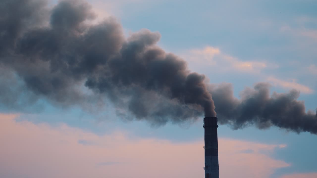 Pipe with smoke from industrial production polluting the air. Dense smoke comes from industrial pipe. Dirty smoke comes from the pipe into the atmosphere. Close-up.
