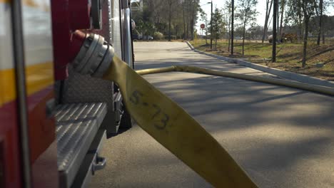 fire hose fills with water at the scene of an emergency