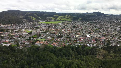 aerial view of whangarei city houses and buildings with scenic mountain views in new zealand