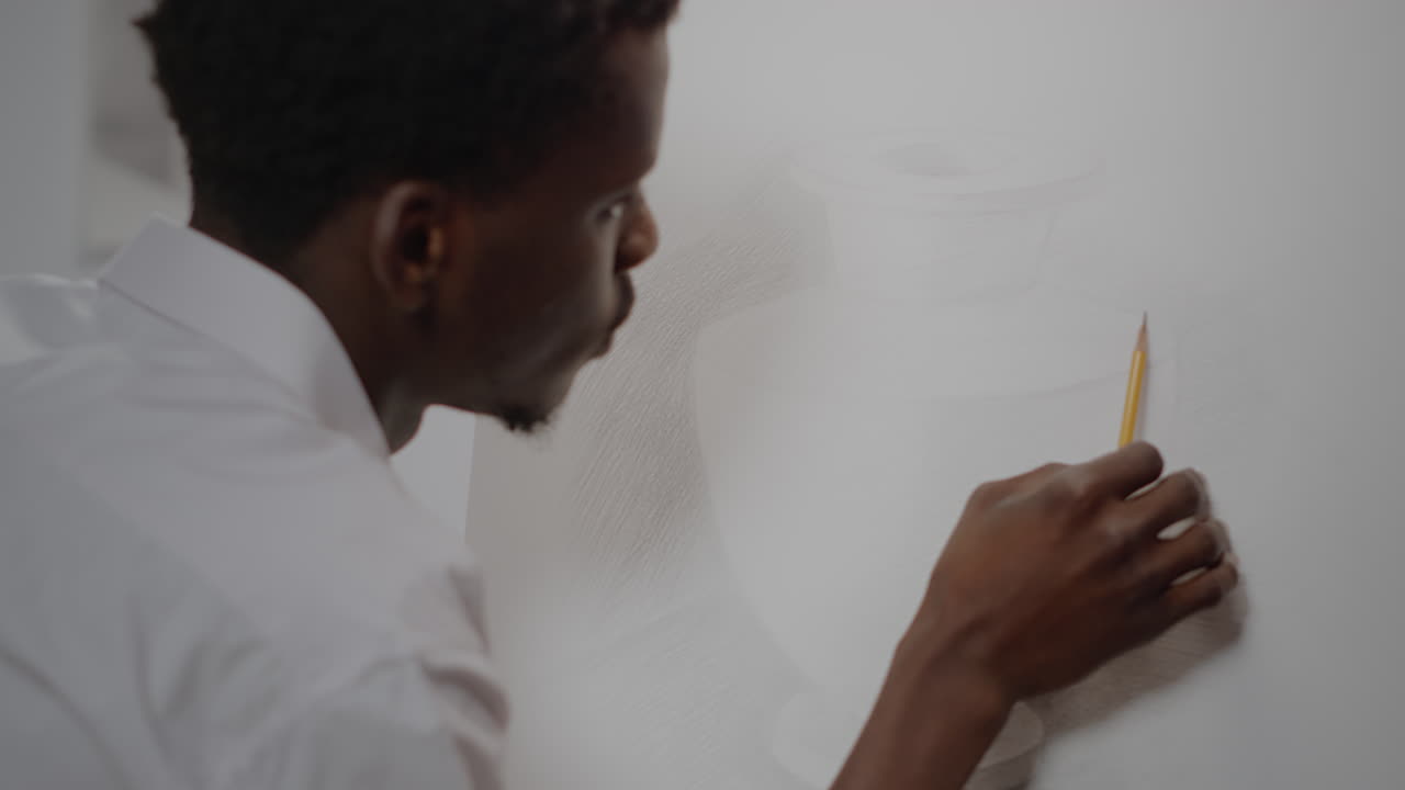 African american artist creating drawing of vase with pencil