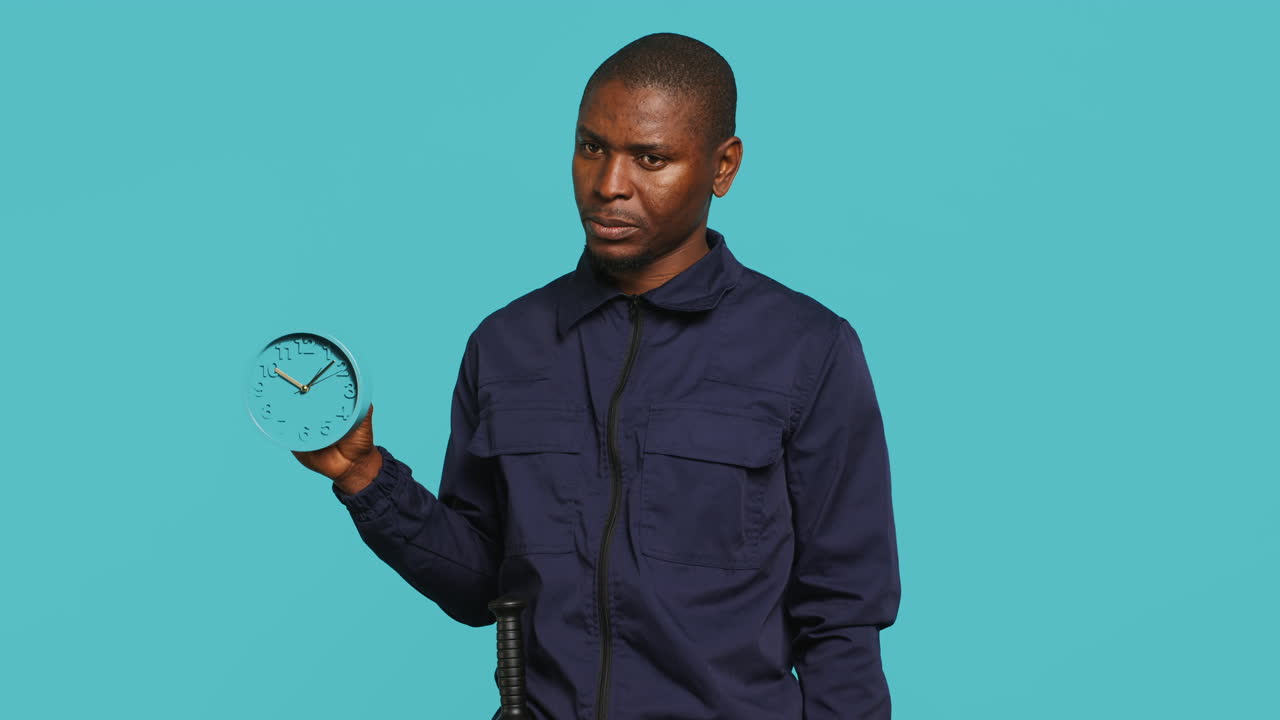 Security guard holding clock, rushing people out of property