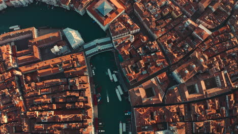 cinematic reveal drone shot of ponte di rialto bridge venice italy at sunrise