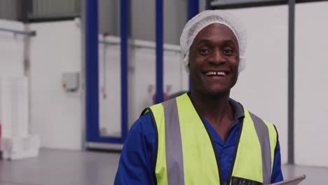 warehouse worker smiling and looking at camera