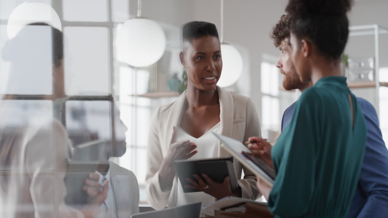 african american business woman manager meeting with corporate team discussing project sharing creative ideas enjoying teamwork in office workspace