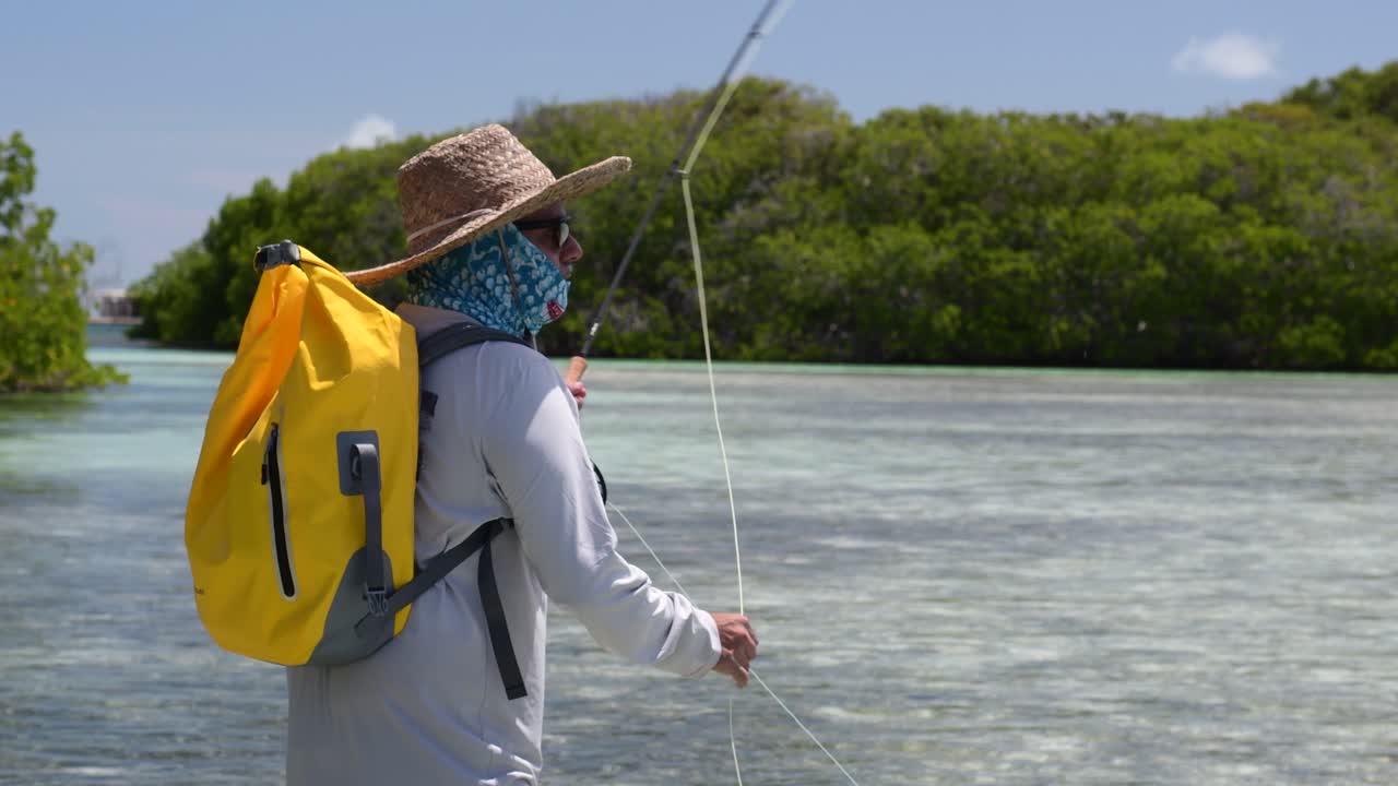 Fly Fisherman Casts His  line in sea shallow water Los Roques venezuela