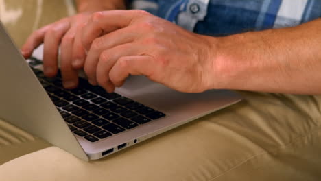 masculine hands typing on a computer