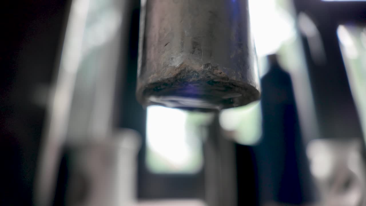 A detailed view of a rusted faucet dripping water, emphasizing texture and motion. slow motion