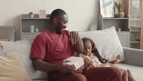 children surprising dad with gift