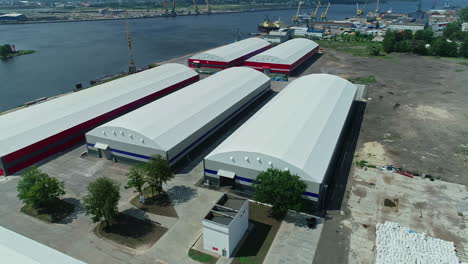 multiple warehouses situated near a dockyard near sea