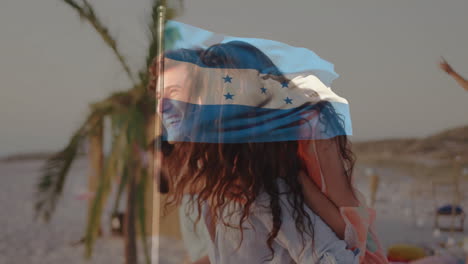 at beach, couple smiling with honduras flag animation overlaying scene