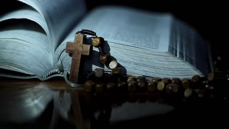 bible with cross on table with black background no people stock footage