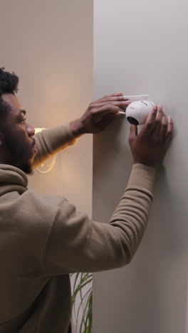 installing a security camera on the wall