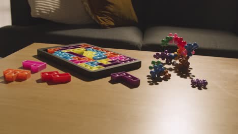 coloured interlocking shape puzzles on table at home for child diagnosed with asd 2