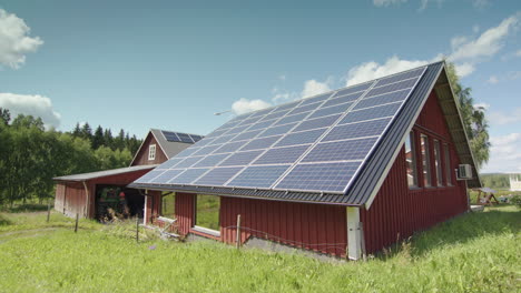 barn roof on farm covered in solar panels, slow aerial trucking shot