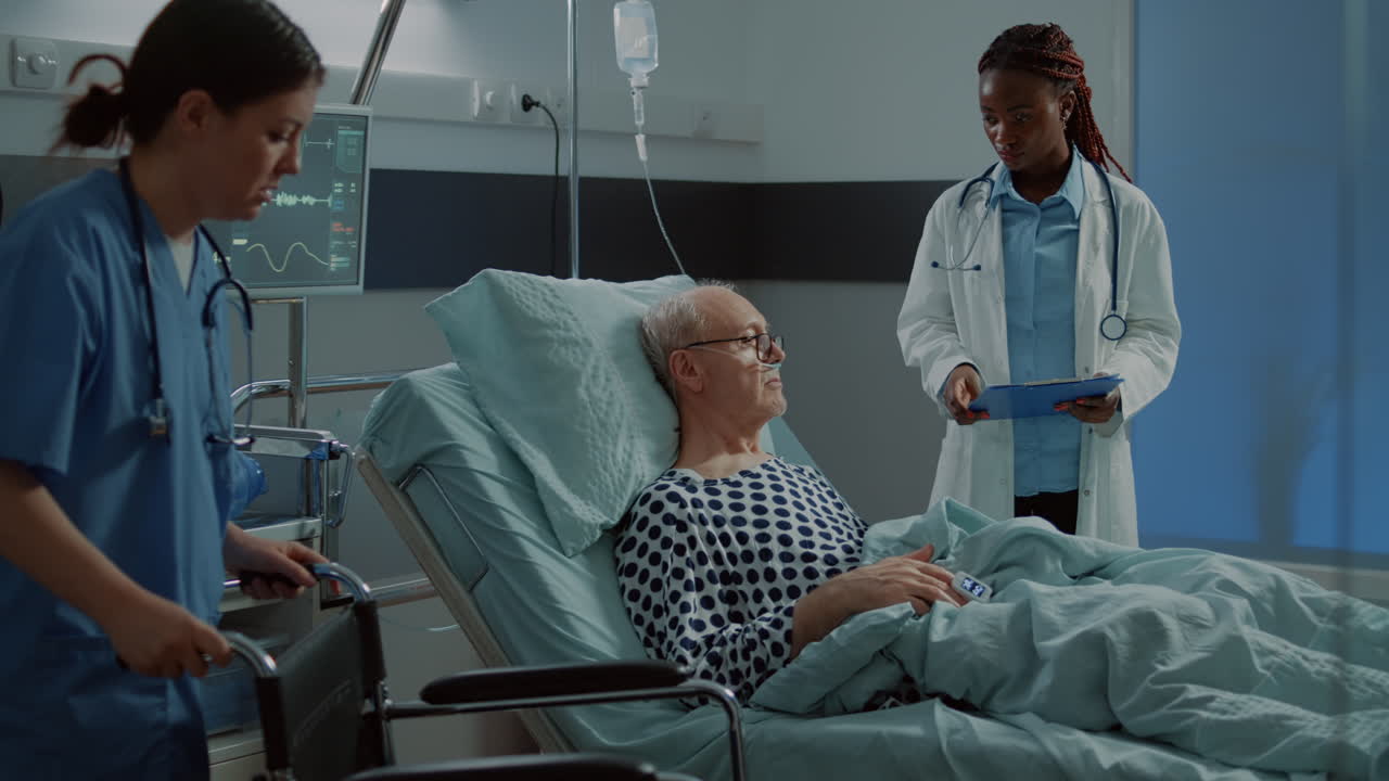 Nurse preparing wheelchair for sick patient in hospital ward