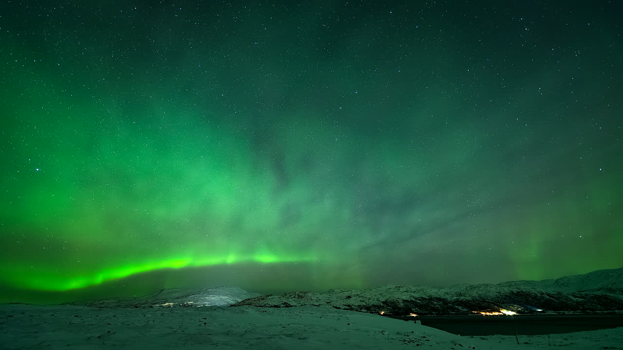 Dazzling Aurora Borealis Lights In Night Sky Over Winter Landscape In Kvaloyvaagen, Norway. timelapse