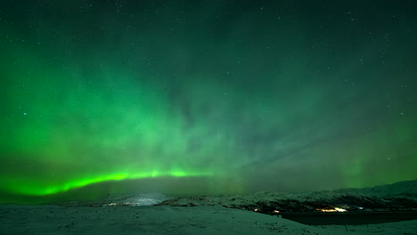 dazzling aurora borealis lights in night sky over winter landscape in kvaloyvaagen, norway. timelapse