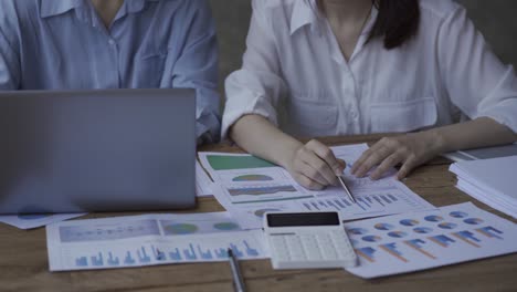 close-up of a financial analyst and a planning team of young entrepreneurs discussing project ideas using papers to brainstorm modern business firms.