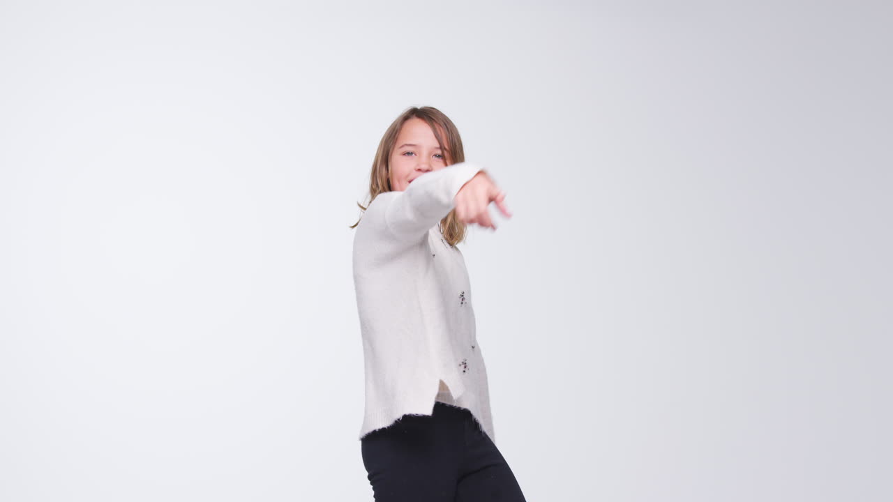 Young Girl Dancing Against White Background In Slow Motion