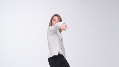 young girl dancing against white background in slow motion