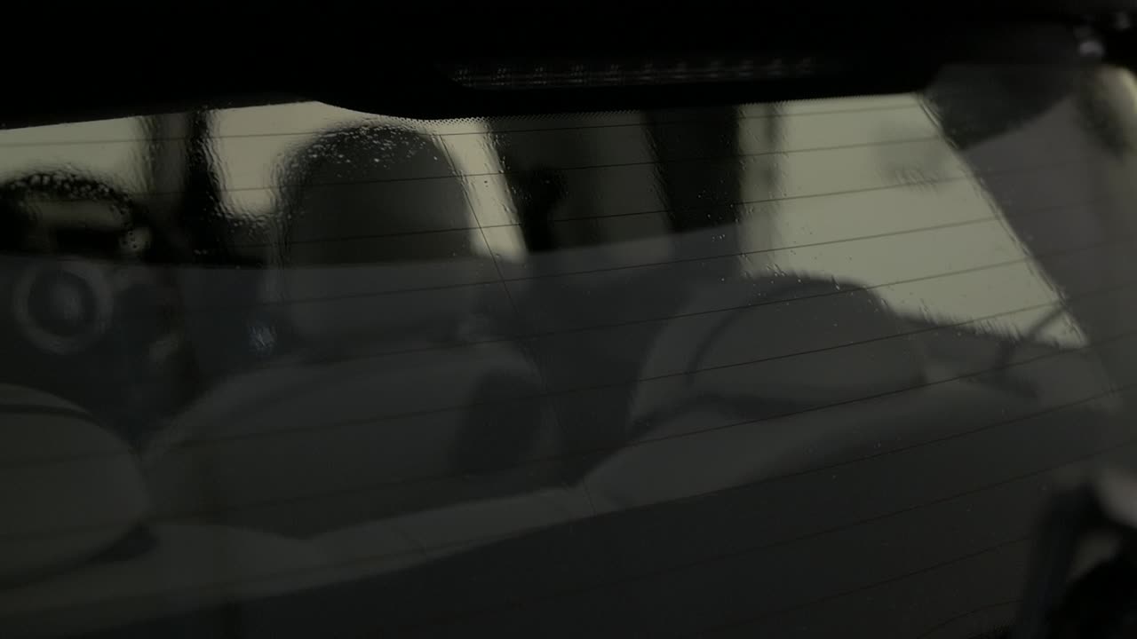 2020 Mini cooper seen through rear window being cleaned for window tint