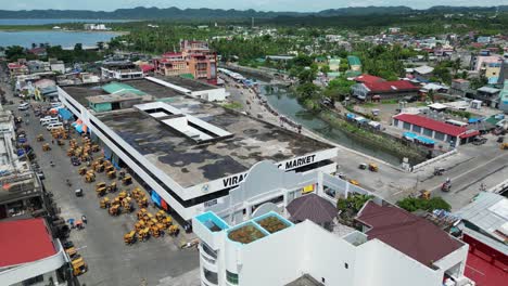 aerial rotating view of a busy seafront public marketplace in virac, catanduanes, philippines