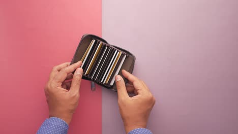 Man-hand-taking-credit-card-out-from-a-wallet