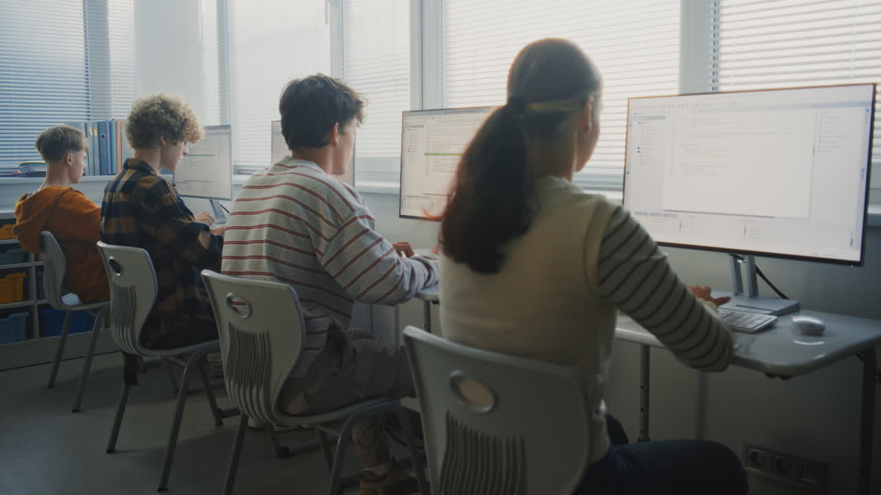 Young Students in Bright Classroom Learning Software Development