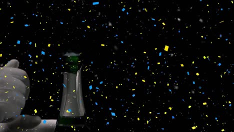 Confetti-falling-over-mid-section-of-person-opening-a-champagne-bottle-against-black-background