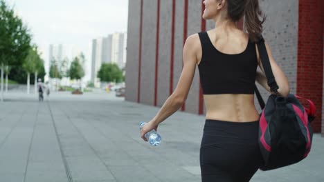 rear view video of  woman coming back from training