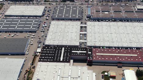 aerial footage of a large shopping centre and car parks located in the city