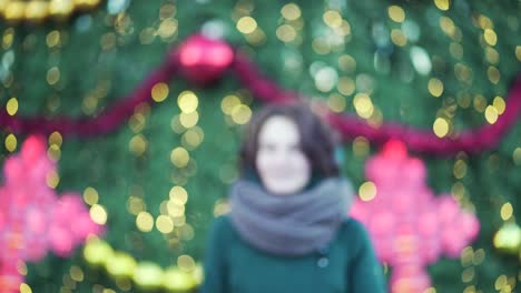 woman in winter outfit near christmas tree