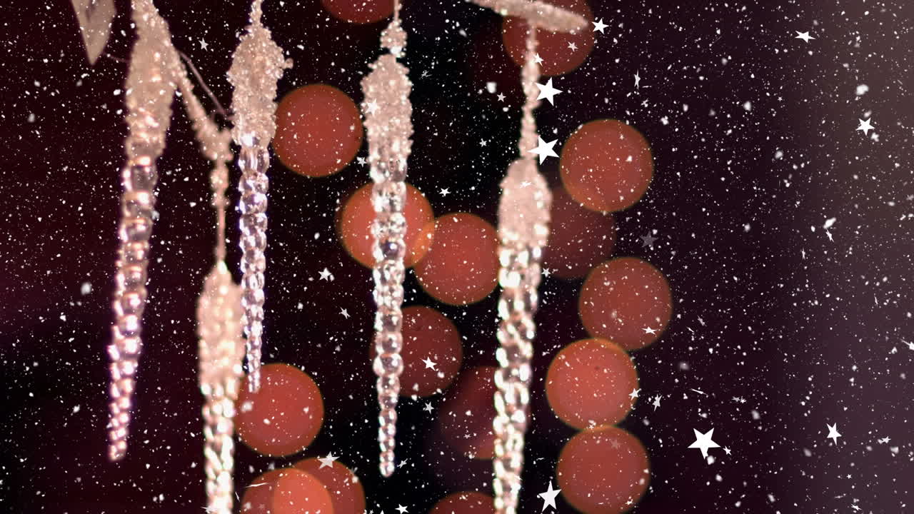 Animation of snow falling over christmas decorations on black background