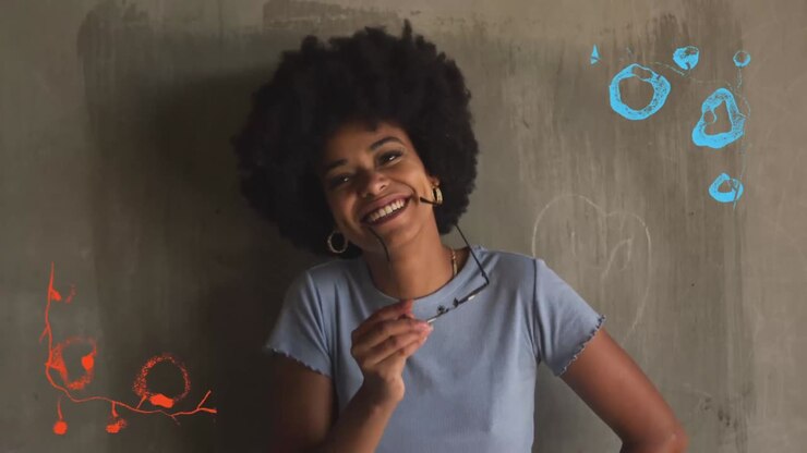 Portrait of a smiling woman with afro hair and sunglasses