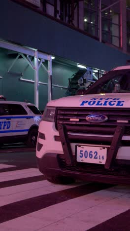 nyc police car on a city street at night