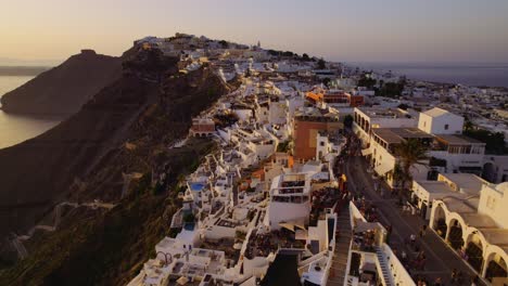 Aerial view of Santorini's iconic white-washed town at sunset