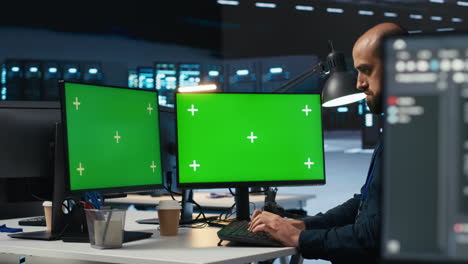 developer programming on multi monitor isolated screen pc setup in data center