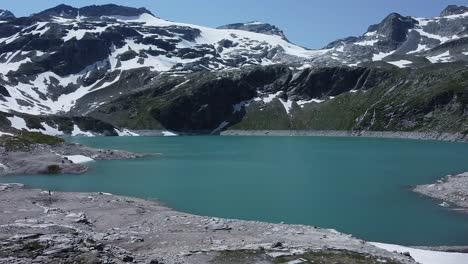 A-beautiful-blue-lake-with-snow-and-ice-in-the-Austrian-Alps,-Uttendorf-Weissee